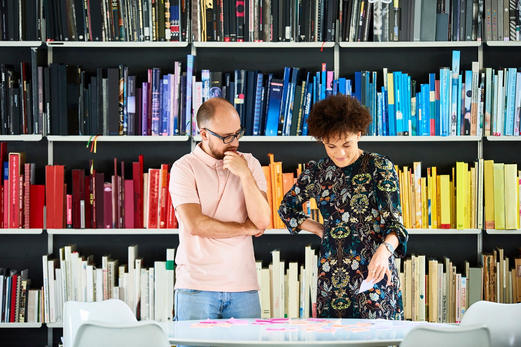 EY - People standing in front of shelves with rainbow colored books