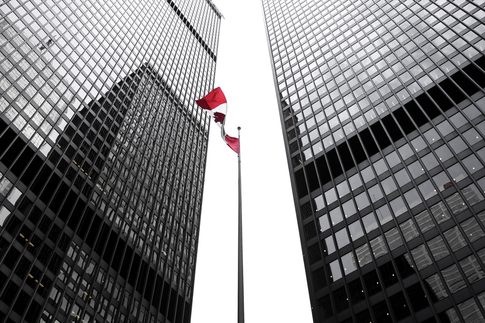 EY Canada flag amongst office buildings 