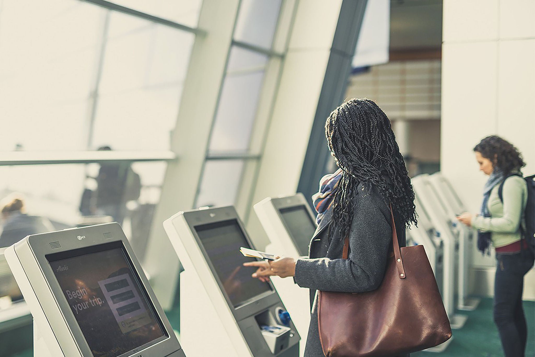  EY - Person signing in at kiosk at airport